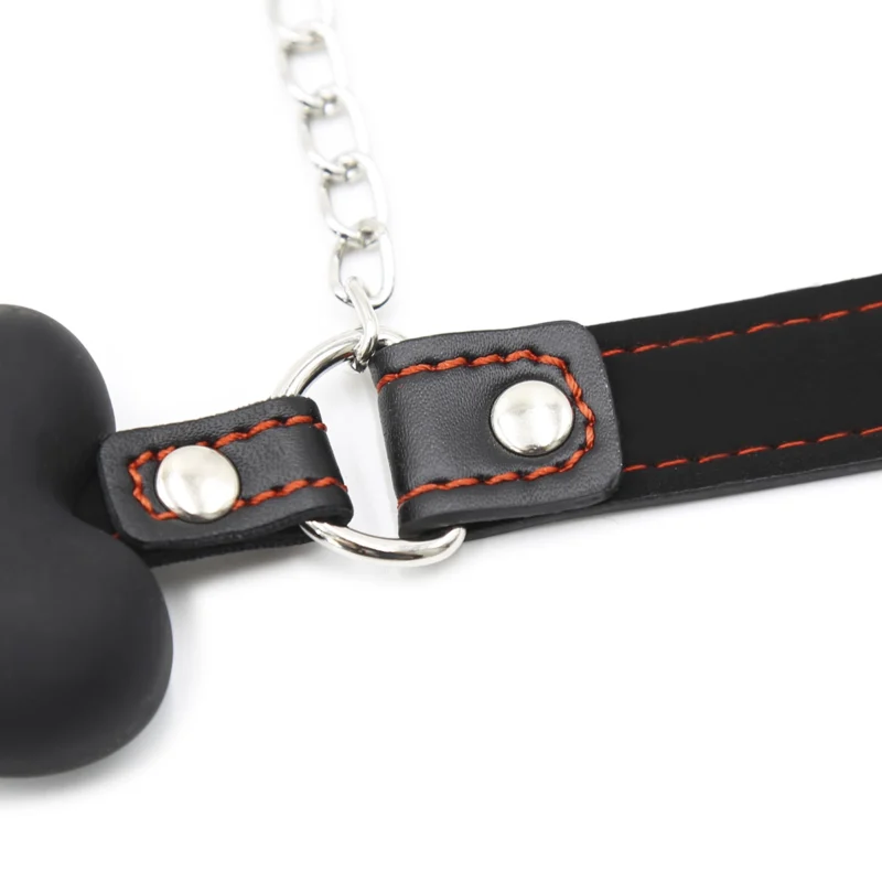 Detail of straps and nipple clamp chain connected to bone type mouth gag