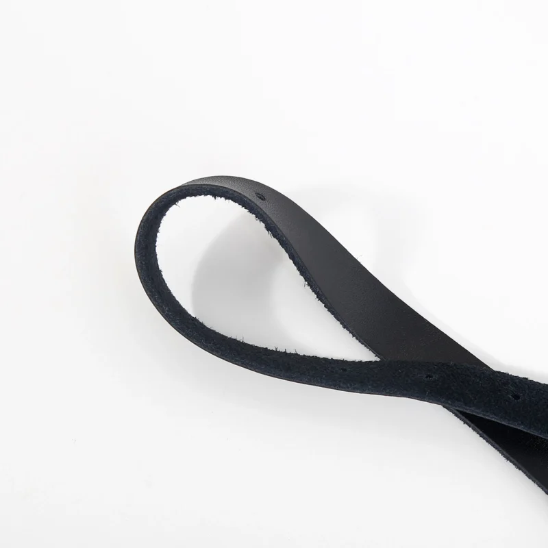 Close-up of genuine leather straps on silk-wrapped O-ring mouth gag showing texture and fibers